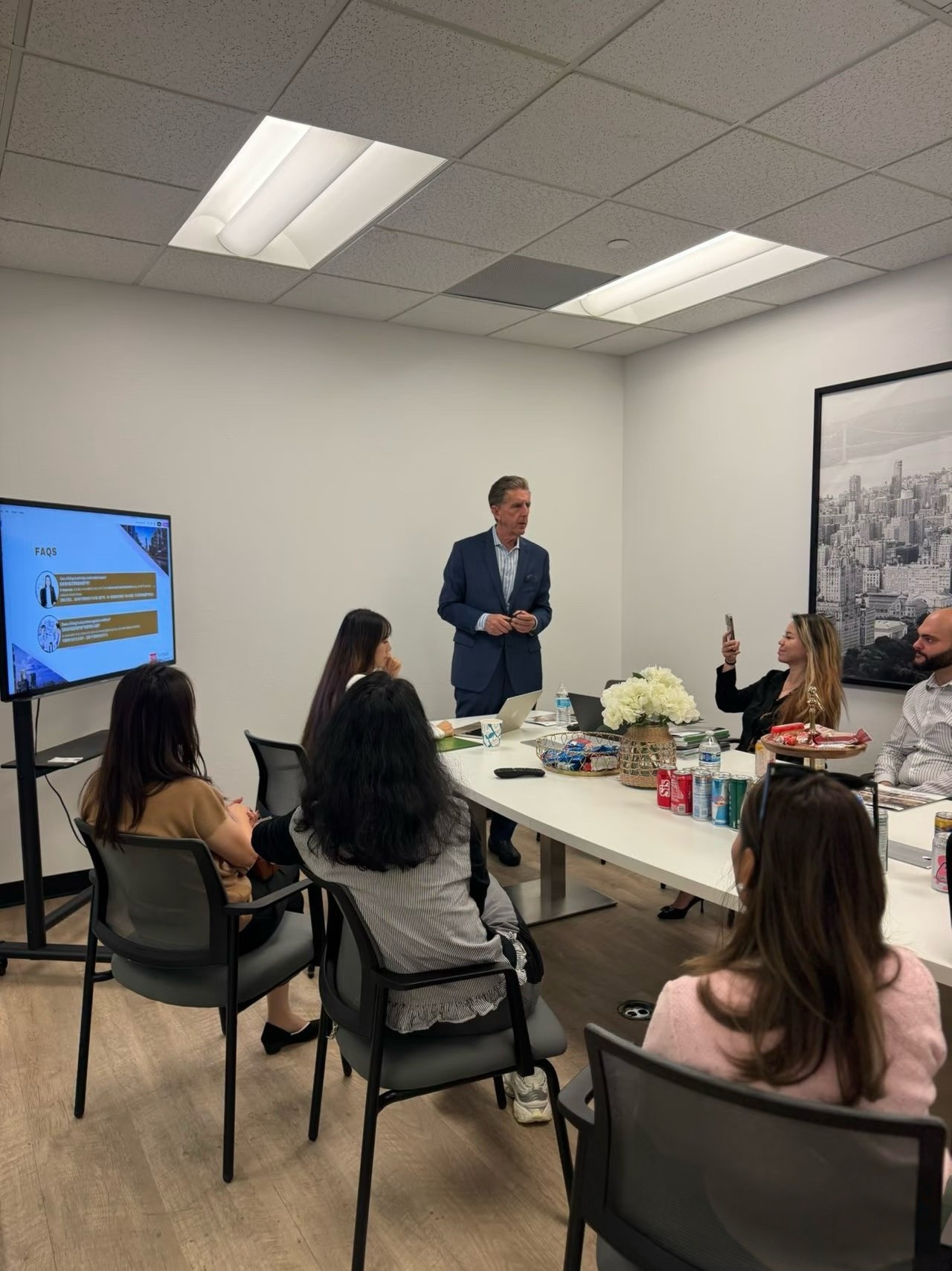 A facilitator leading an interactive professional workshop for a seated group